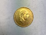 l'image d'une pièce d'or sur laquelle figure le visage d'un homme