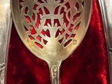 a silver spoon and a silver spoon on a red cloth