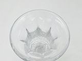 a glass with a fish inside of it sitting on a table