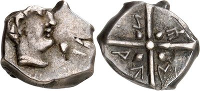 an image of a silver coin with a face on it