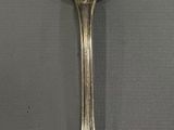 silver spoon on a gray surface with a black background