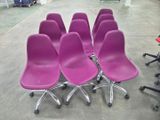 six purple chairs sitting on top of each other in a room