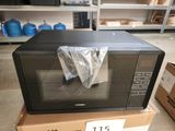 a microwave sitting on top of a box in a store