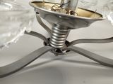a silver candle holder with a glass candle on it