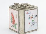 a small silver box with a picture of birds on it