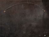 an image of a black piece of metal with a wire hanging from it