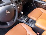 the interior of a car with brown leather seats and a steering wheel