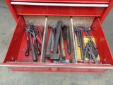 a red tool box with tools in it on the floor