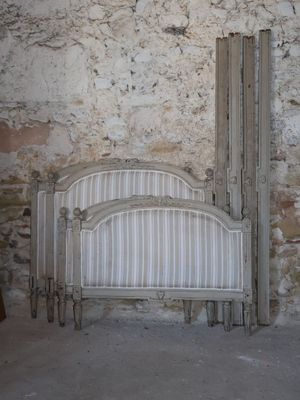a bed that is in front of a stone wall