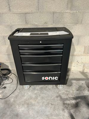 an image of a black tool cabinet sitting on top of a cement floor