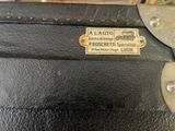 a close up of a black suitcase with a label on it