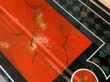 a glass table with a black and red design on it