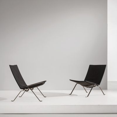 two black chairs sitting on top of a white platform