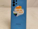 the back of a blue samsung galaxy s20 with a sticker on it