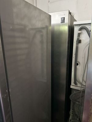 two refrigerators that are next to each other in a room