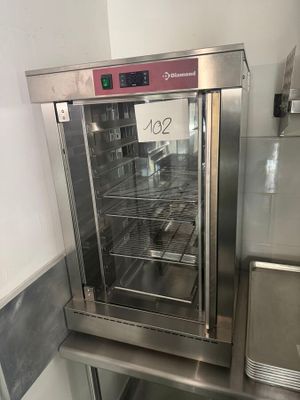 a commercial oven with a glass door in a kitchen
