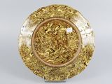 a gold plate with a circular design on it