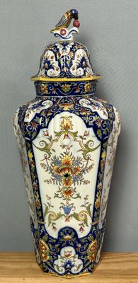a large blue and white vase sitting on a wooden table