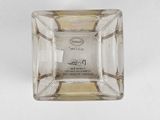 a glass square shaped object with a label on it
