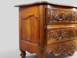 an old wooden chest of drawers with ornate carvings on the drawers