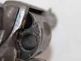a close up of a gun on a white surface