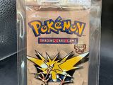 a close up of a pokemon trading card game in a plastic case