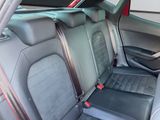 the back seats of a car are black and grey with red trims