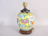 an image of a yellow and blue vase with flowers on it