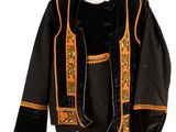 an image of a black jacket with orange trims on a mannequin