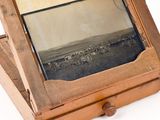 a wooden box with a mirror on top of it