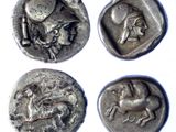 four ancient silver coins with a horse and rider on them