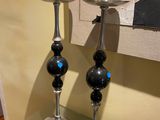two candles that are sitting on a glass table
