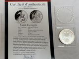 a silver coin with a picture of a woman and a man on it