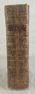an old book sitting on top of a table next to a white wall