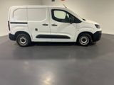 the white van is parked in a large room with grey flooring