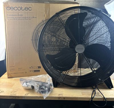 un ventilateur posé sur une table à côté d'une boîte