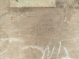 a piece of wood with graffiti on it and a sign on it