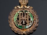 a close up of a badge with a crown on top of it