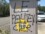 graffiti on the side of a utility box on the side of the road