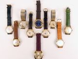 several different types of watches are lined up on a white surface