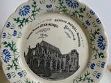 a plate that has a picture of a church on it