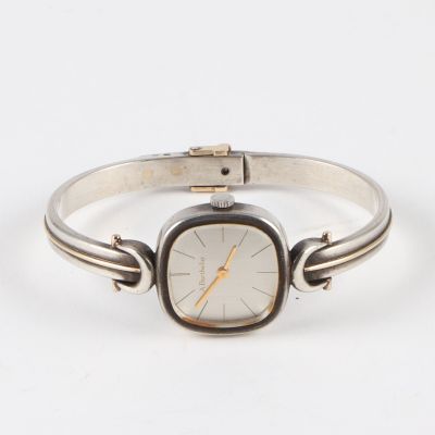 an image of a wrist watch with a silver band and a gold face