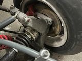 a close up of a car ' s front wheel and suspension
