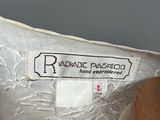 a close up of a white shirt with a label on it