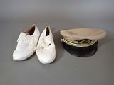 two pairs of shoes and a hat on a table