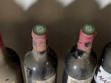 several bottles of wine are lined up in a row on a counter