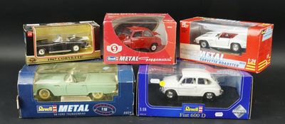 three boxed models of toy cars in boxes on a black surface