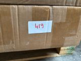 a cardboard box with a tag on it sitting on a pallet