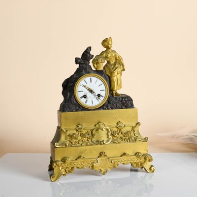 a gold clock sitting on top of a white table