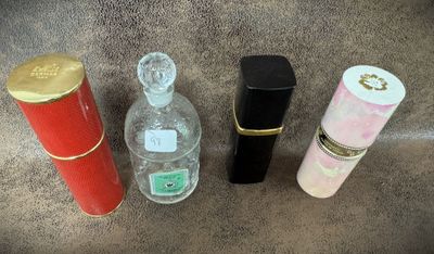 three bottles of perfume are lined up next to each other on the floor